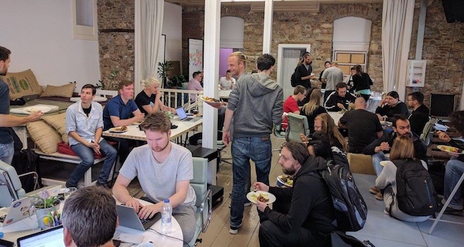 Coworking space with people working and eating.